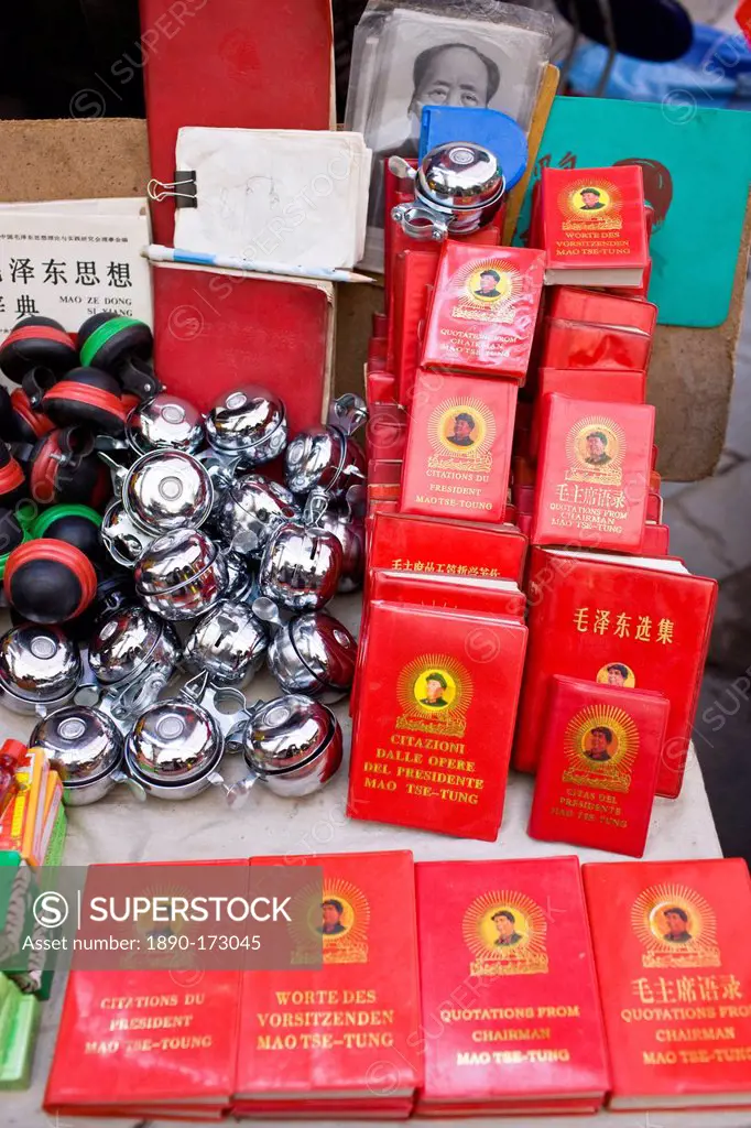 Chairman Mao's Little Red Book and bicycle bells for sale on market stall in Moslem district of Xian, China