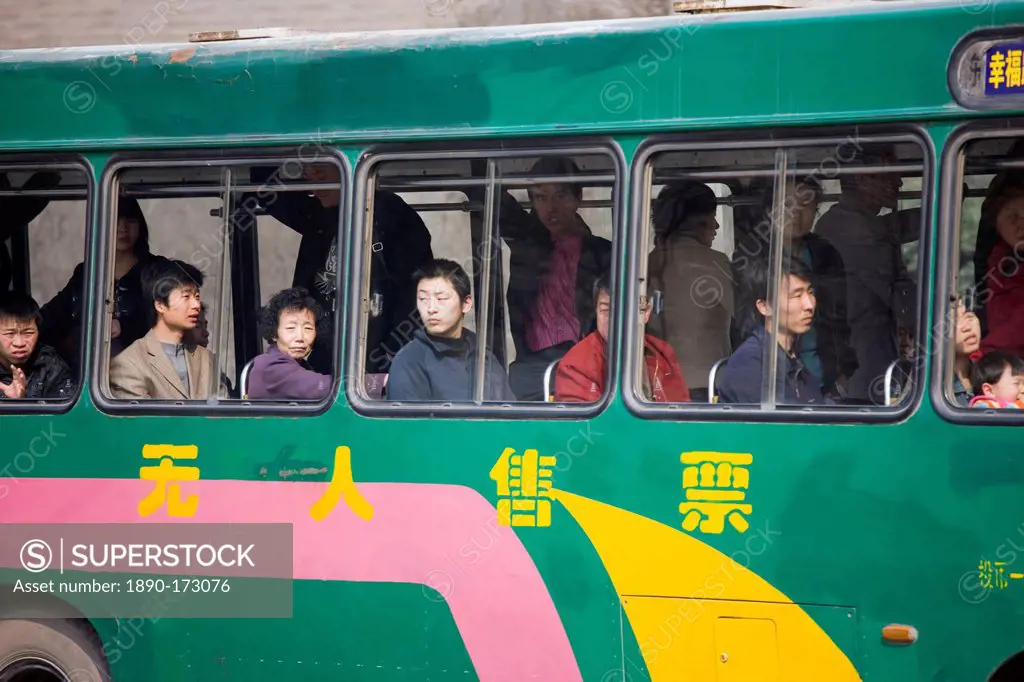 Bus carries workers home in rush hour, Xian city centre, China