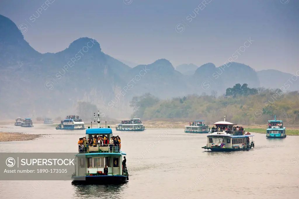 Tourist boats travel along Li River between Guilin and Yangshuo, China
