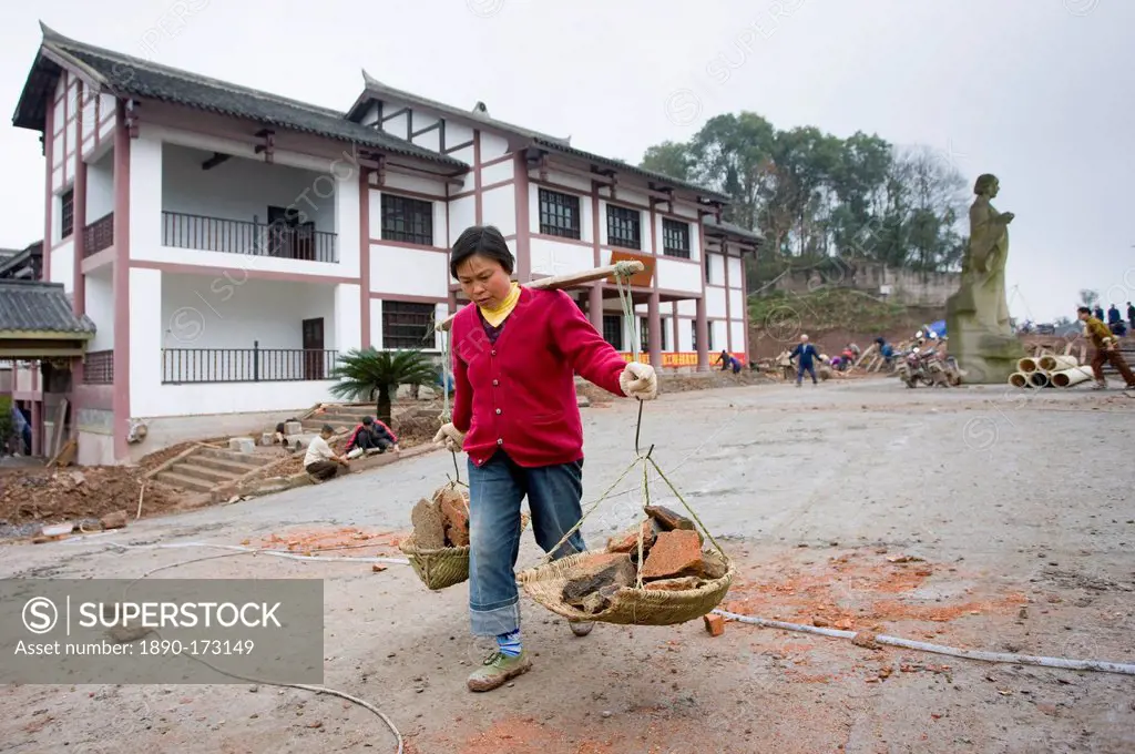 Woman at work building new tourist centre at Dazu Rock Carvings, Mount Baoding, Chongqing, China