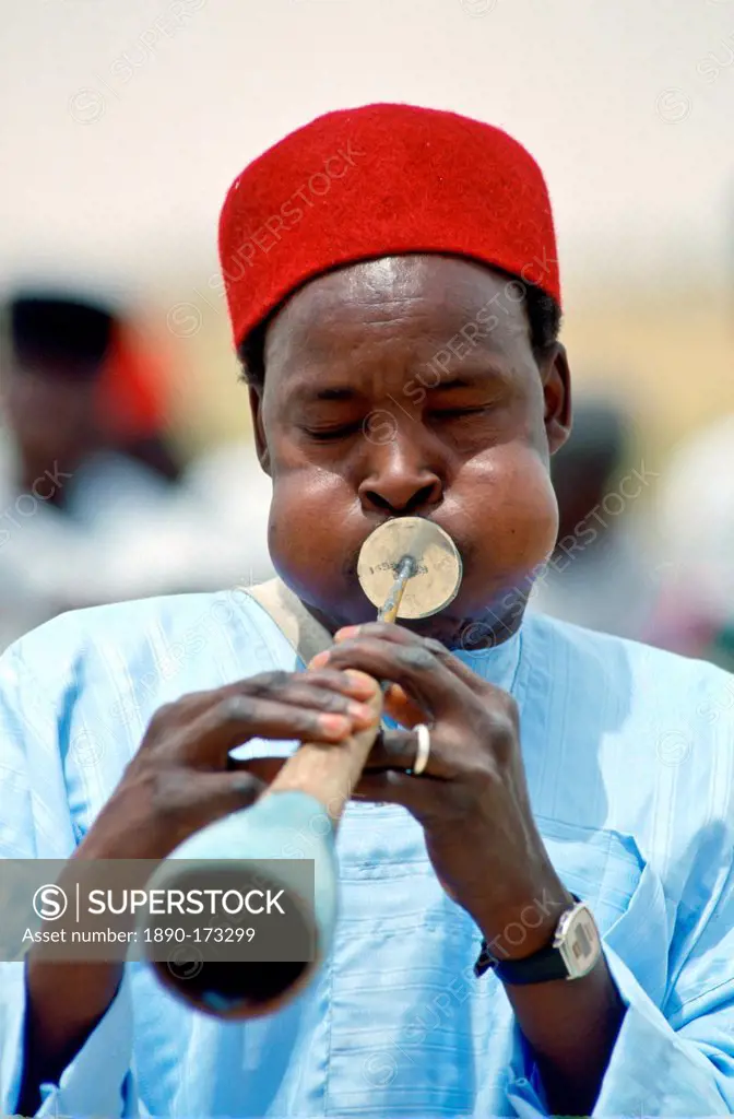 Musician playinga traditional wind instrument, Nigeria