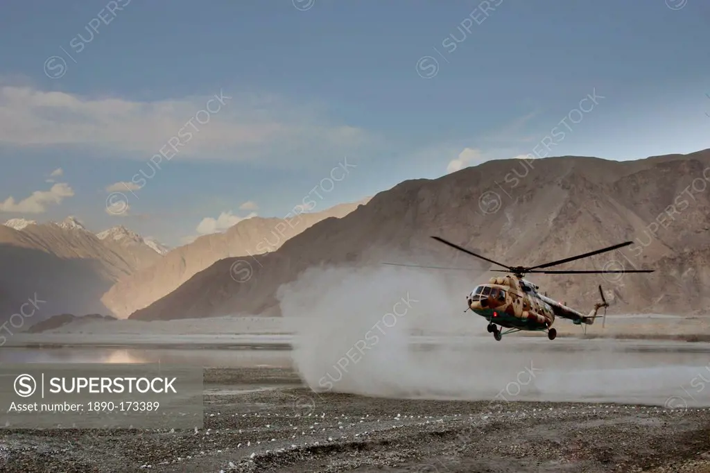 Helicopter lands on heliport in valleys of Karokoram Mountains, Skardu Valley, North Pakistan