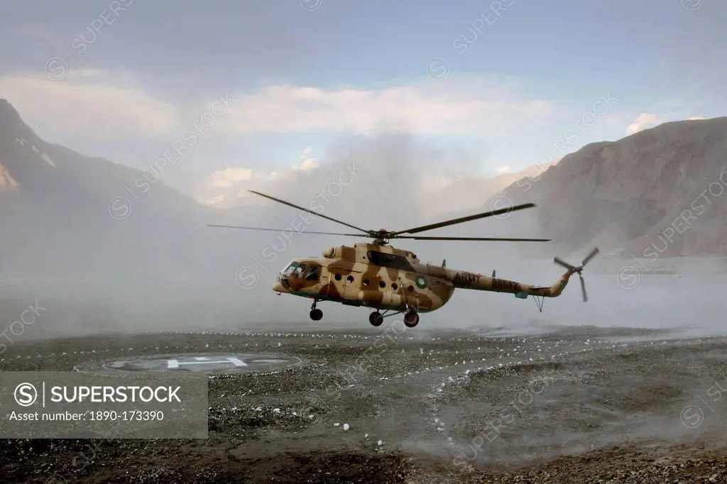 Helicopter landing on heliport in valleys of Karokoram Mountains, Skardu Valley, North Pakistan
