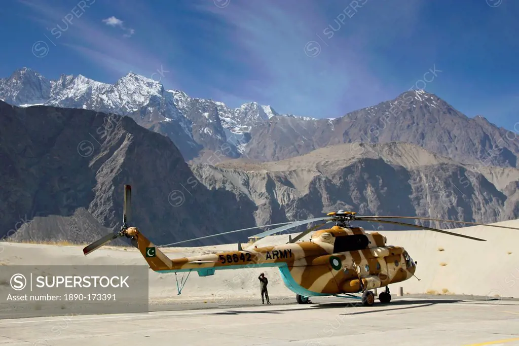 Helicopter on heliport in valleys of Karokoram Mountains, Skardu Valley, North Pakistan