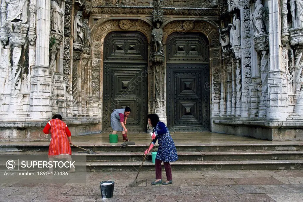 Women cleaning the steps outside a church in Lisbon, Portugal.
