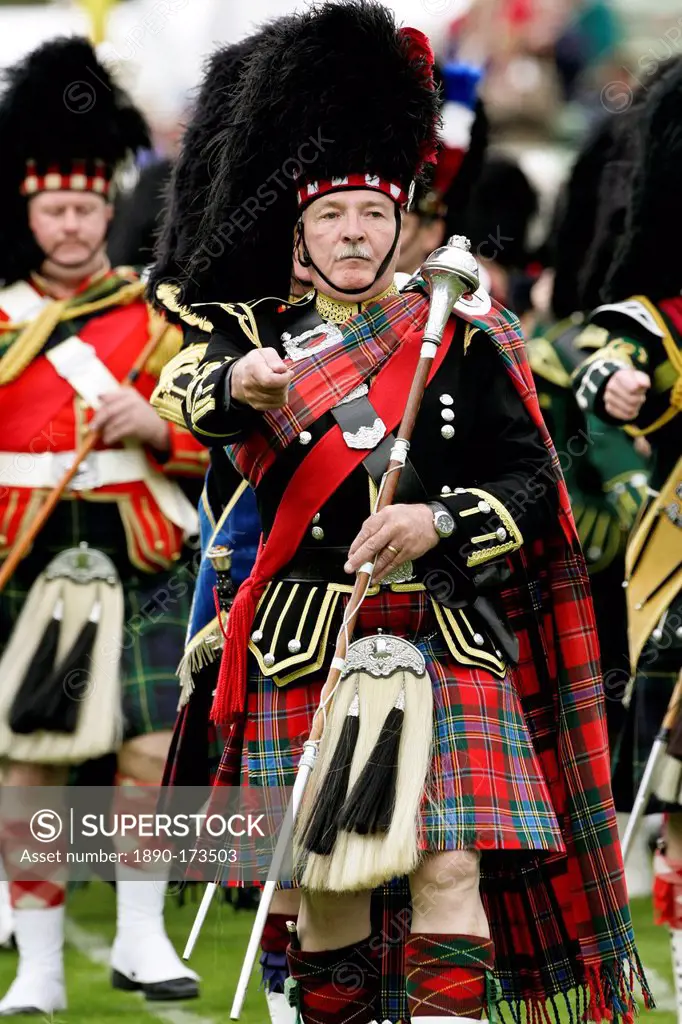 Drum Major leads massed band of Scottish pipers at the Braemar Games Highland Gathering