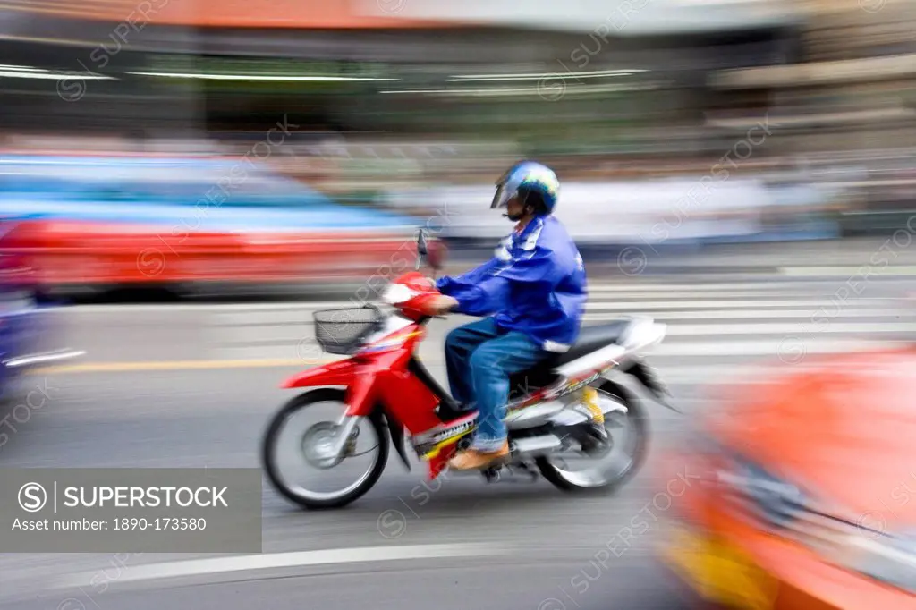 Commuter travelling on a scooter, Bangkok, Thailand