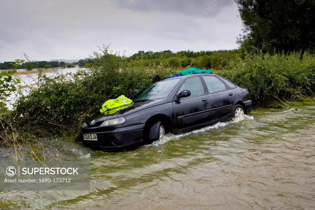 Car forced off the road by flooding in Lyneham, Oxfordshire, England, United Kingdom