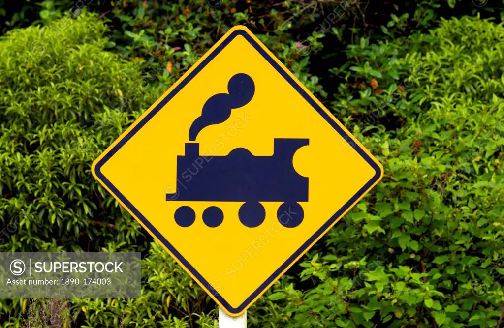 Road traffic sign look out for trains on railway crossing, North Island, New Zealand