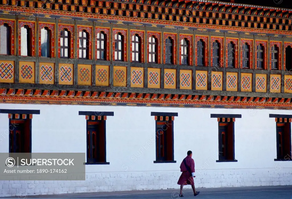 Man walking at the Tashichho Dzong, home of Government, Royal Palace and Religious Centre in Thimpu, the capital of Bhutan.