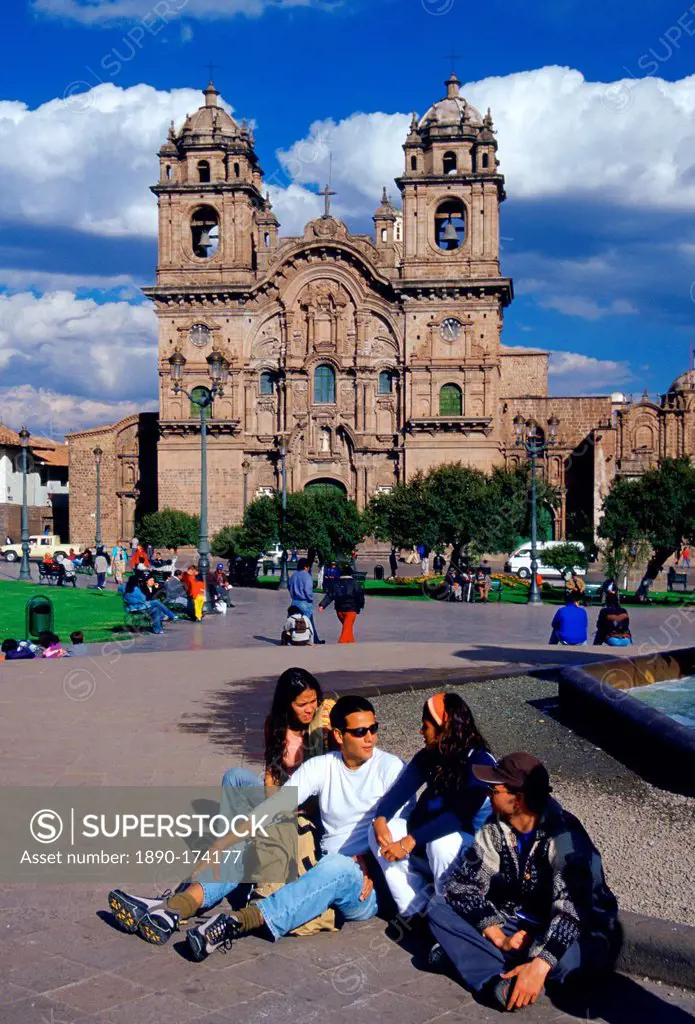 Young people gather in front of La Compania Church, Plaza de Armas square in Cuzco, the ancient capital of the Inca Empire, Peru, South America