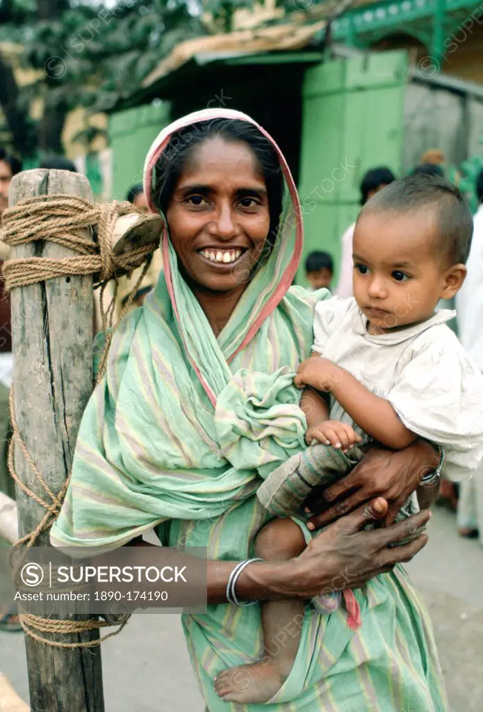 Mother holding child, street scene, India