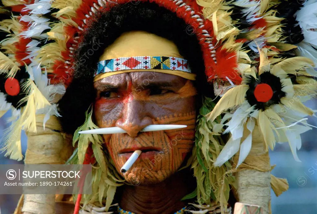 A cigarette between the lips matches the bone through his nose for this man at a Sing Sing tribal gathering in Papua New Guinea