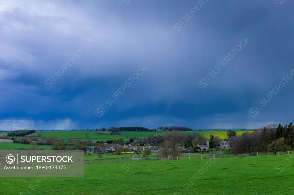 Rainstorm from Cumulonimbus cloud above Asthall Village in springtime in the Cotswolds, Oxfordshire, UK