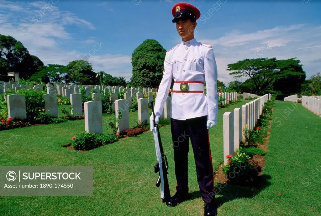 Soldier standing on guard over Commonwealth war graves at Krangi War Cemetery in Singapore