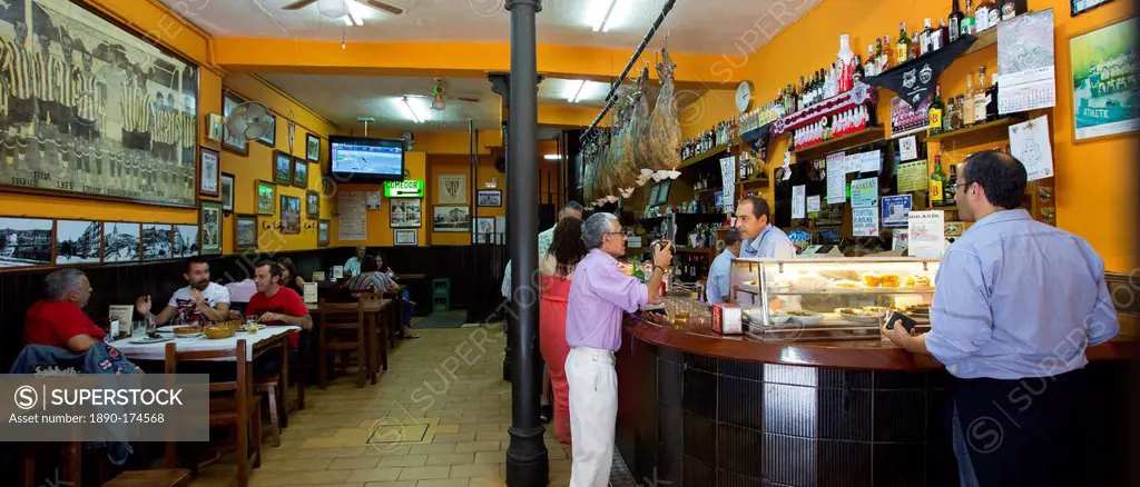 Locals in traditional Spanish Tapas Raciones bar in Bilbao, Spain