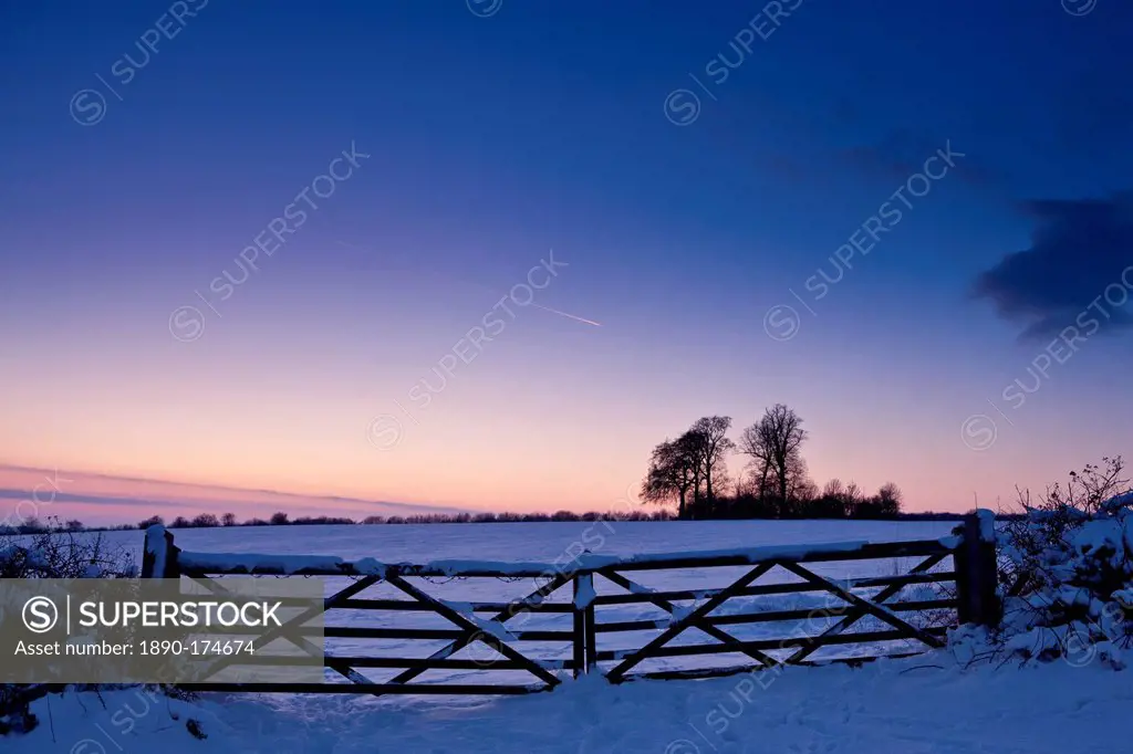 Farm gate in traditional snow scene in The Cotswolds, Swinbrook, Oxfordshire, United Kingdom