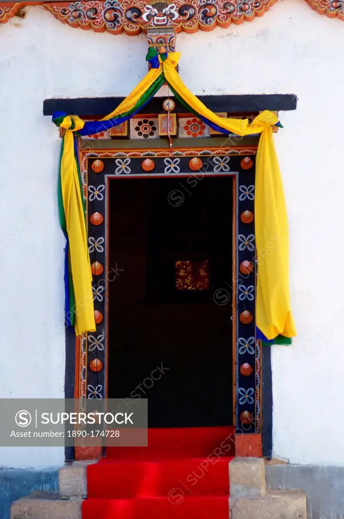 Traditional decorated doorway of the Institute of Traditional Medicine with a modern day fluorescent light above it, Paro, Bhutan.
