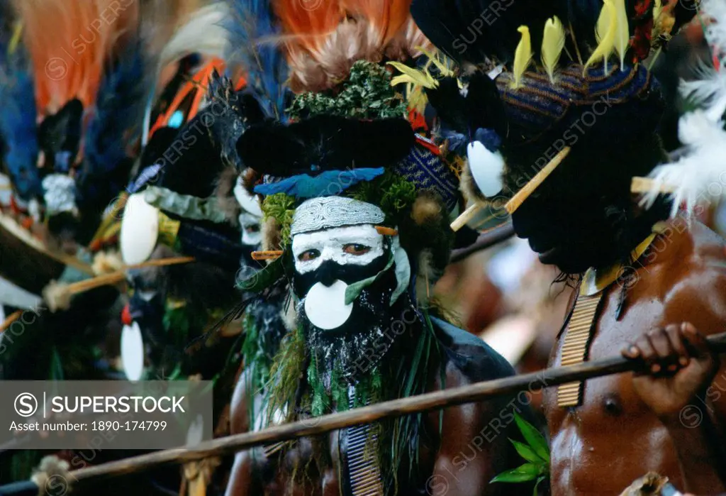 Bearded tribesmen wearing war paints and feathered headdress during a gathering of tribes at Mount Hagen in Papua New Guinea