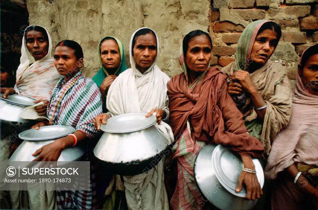 Women carrying pots in early morning food queue at Mother Teresa's Mission in Calcutta, India