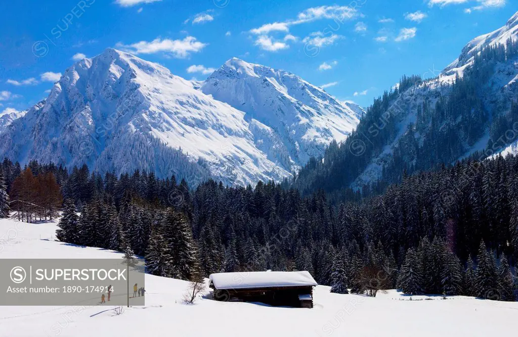 Snow covered barns in the meadows below the Alps at Klosters - Amongst the Silvretta group of the Swiss Alps. Road to Silvretta.Mountain at right is P...