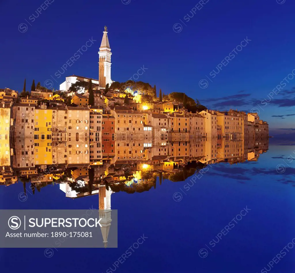 Old town with cathedral of St. Euphemia reflecting in the water at night, Istria, Croatia, Europe