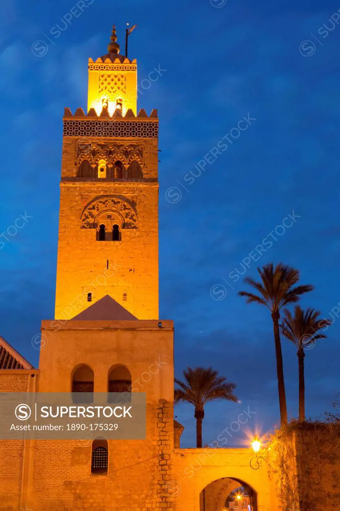 The Minaret of the Koutoubia Mosque illuminated at dusk with palm trees, UNESCO World Heritage Site, Marrakech, Morocco, North Africa, Africa