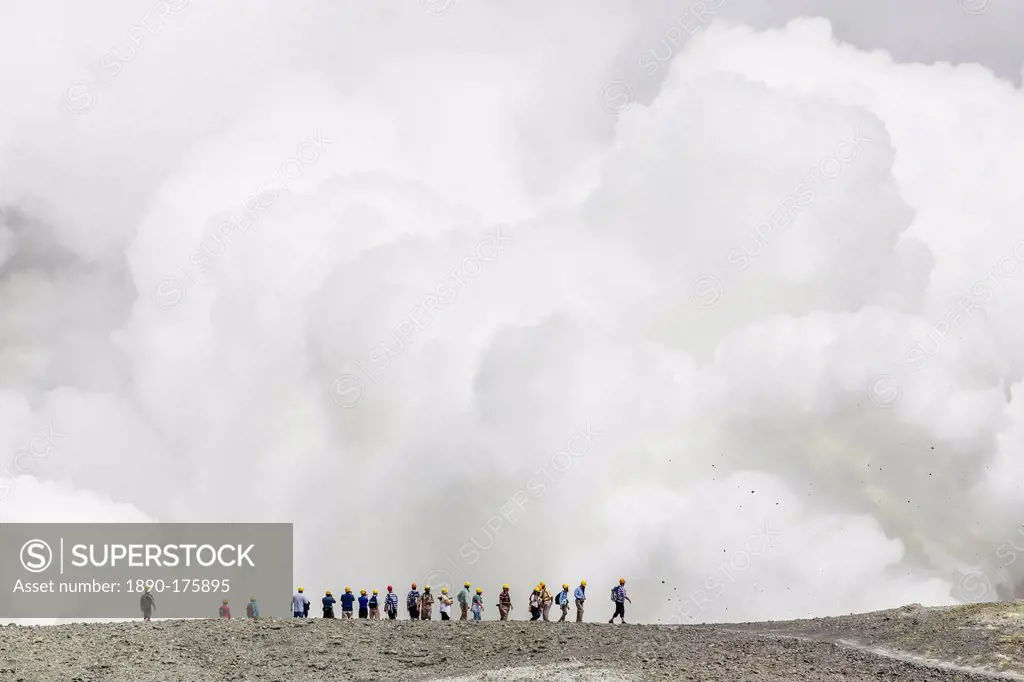 Visitors watching mud being ejected from the caldera floor of an active andesite stratovolcano on White Island, North Island, New Zealand, Pacific