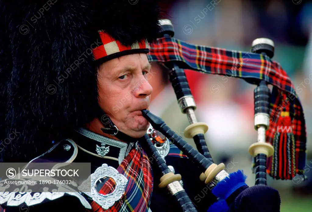 Scottish Piper playing bagpipes at the Braemar Games, Braemar, Scotland