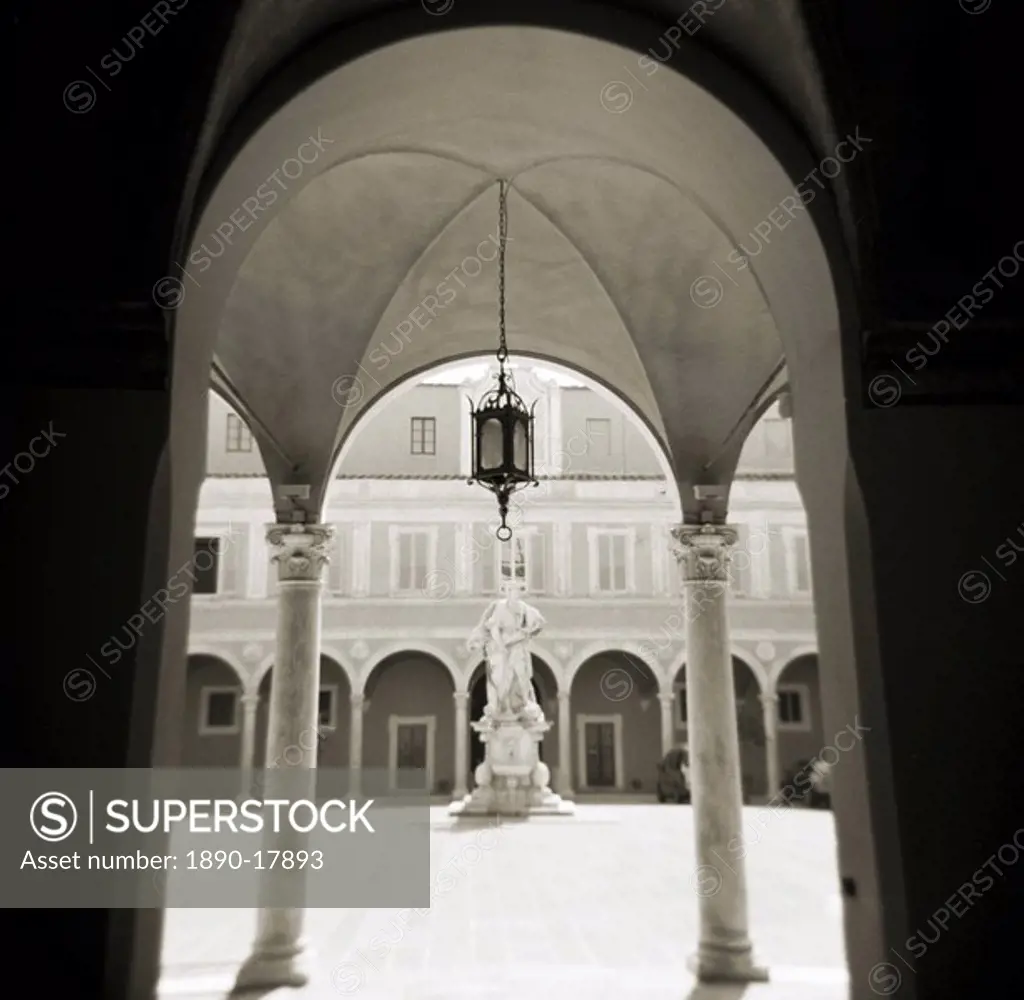 Image taken with a Holga medium format 120 film toy camera of view through archways into sunlit courtyard, Pisa, Tuscany, Italy, Europe