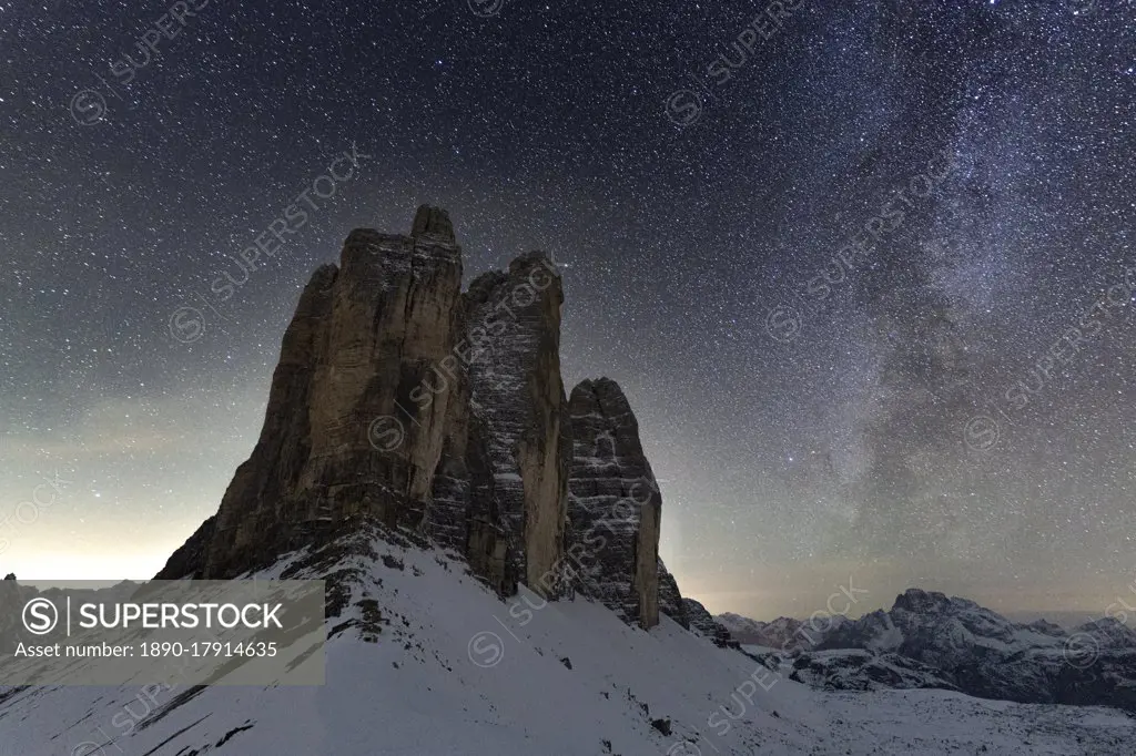 Stars in the night sky over the majestic rocks of Tre Cime di Lavaredo, Sesto Dolomites, South Tyrol, Italy, Europe