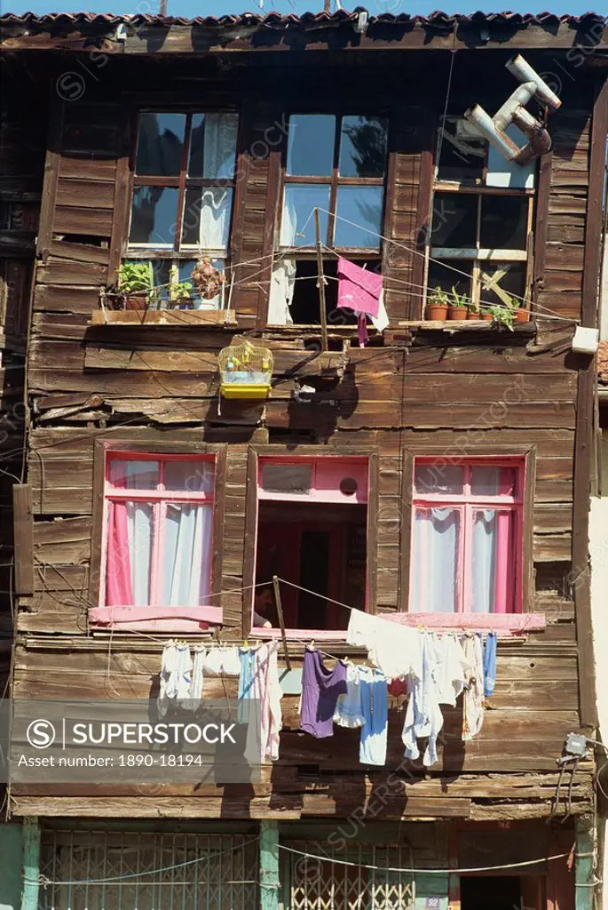 Bird cage and washing lines on the front of a traditional wooden house in the old city of Istanbul, Turkey, Europe