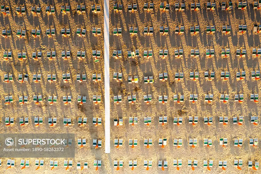 Aerial view of rows of lounge chairs and sunbeds on empty sand beach, Vieste, Foggia province, Gargano, Apulia, Italy, Europe