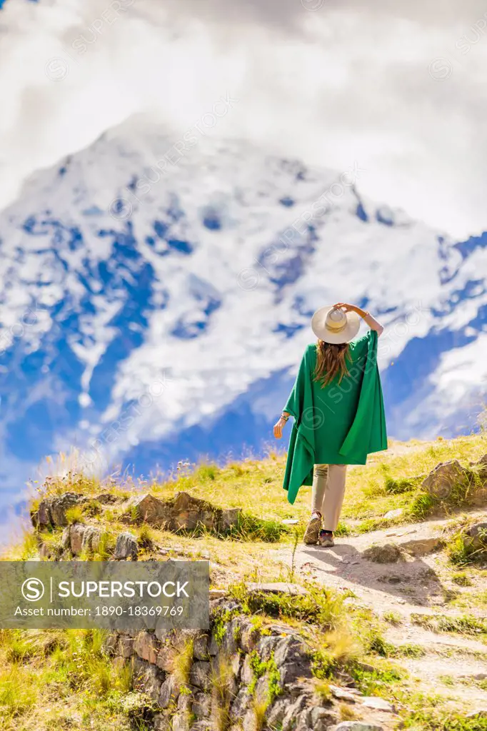 Woman enjoying the view high in the Andes Mountains while exploring Inti Punku (Sun Gate), Cusco, Peru, South America