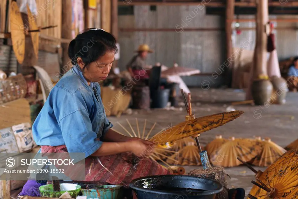 Woman making umbrellas with brown paper at the Umbrella factory at Bo Sang, Chiang Mai, Thailand, Southeast Asia, Asia