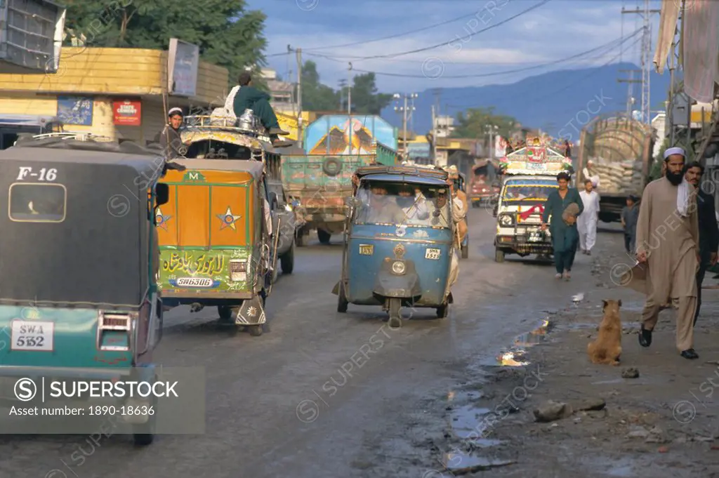 Three wheeled vehicles on main road, Mingora, Swat valley, North West Frontier Province, Pakistan, Asia