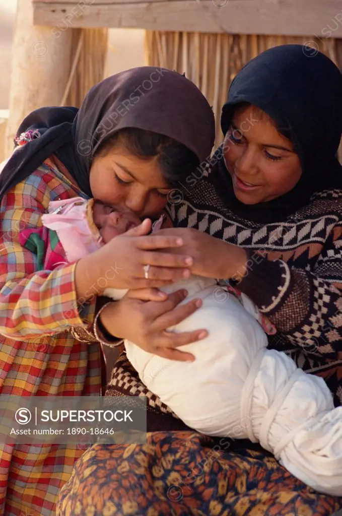 Bedouin children with newborn baby in swaddling cloth, Syria, Middle East