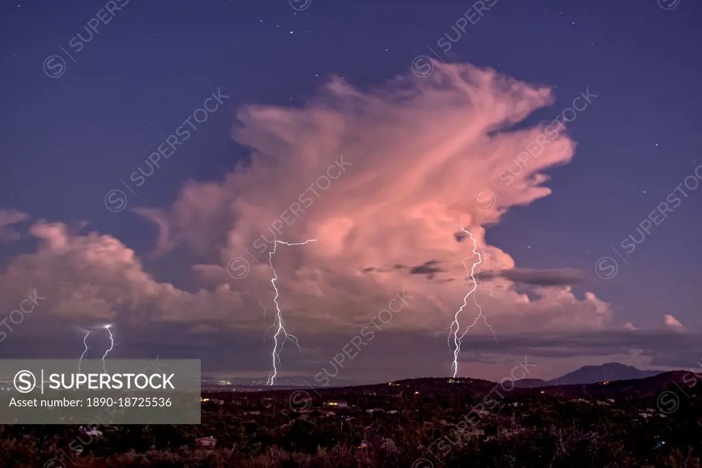Isolated storm cell passing over the Prescott area of Arizona in the distance with the town of Chhino Valley in the foreground, Arizona, United States of America, North America