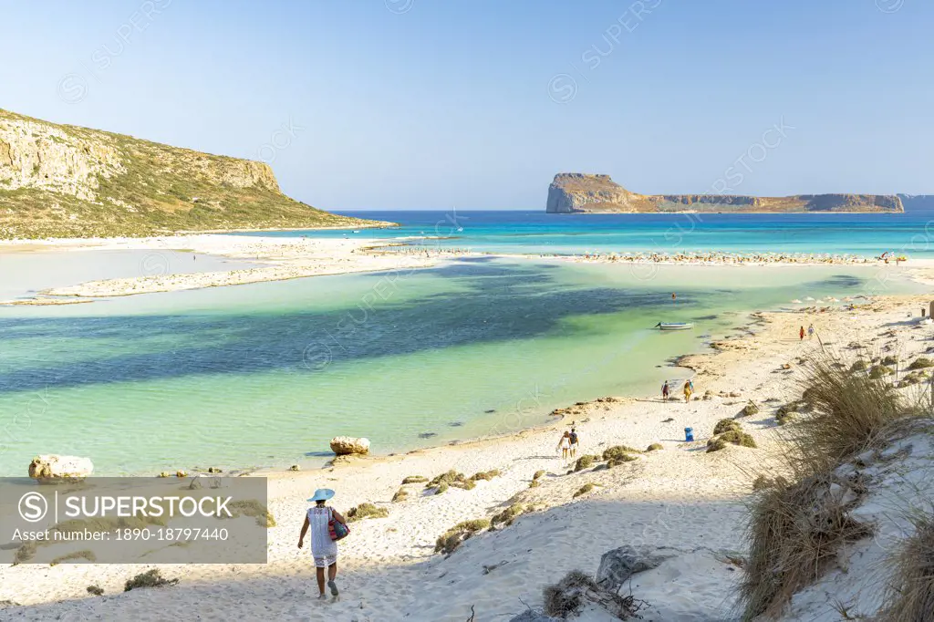 Tourists walking to the white sand beach surrounding Balos lagoon, Crete, Greek Islands, Greece, Europe