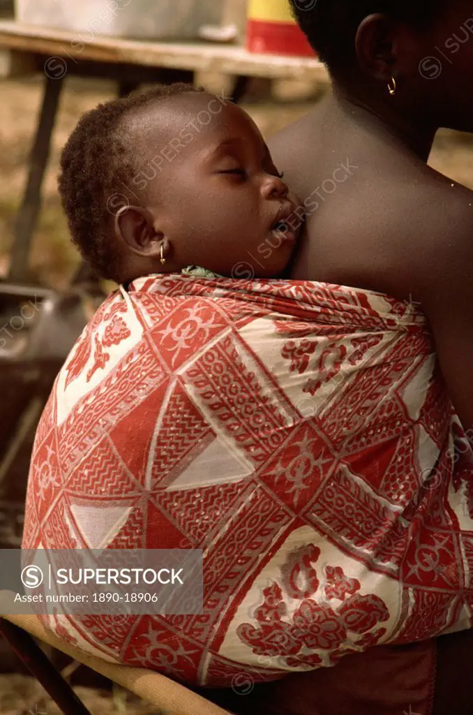 Baby asleep on girl´s back, near Abidjan, Ivory Coast, West Africa, Africa