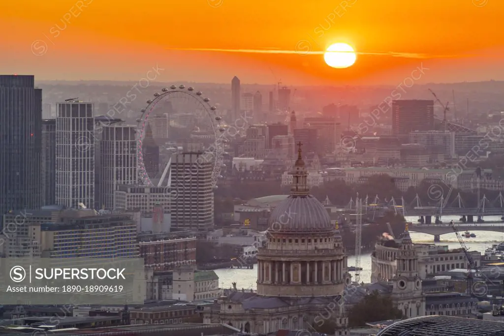 View of sun setting over London Eye and St. Paul's Cathedral from the Principal Tower, London, England, United Kingdom, Europe