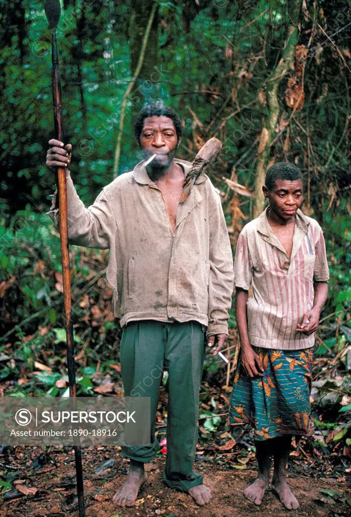 Pygmy man posing with his wife and hunting spear, southeast area, Cameroon, Africa