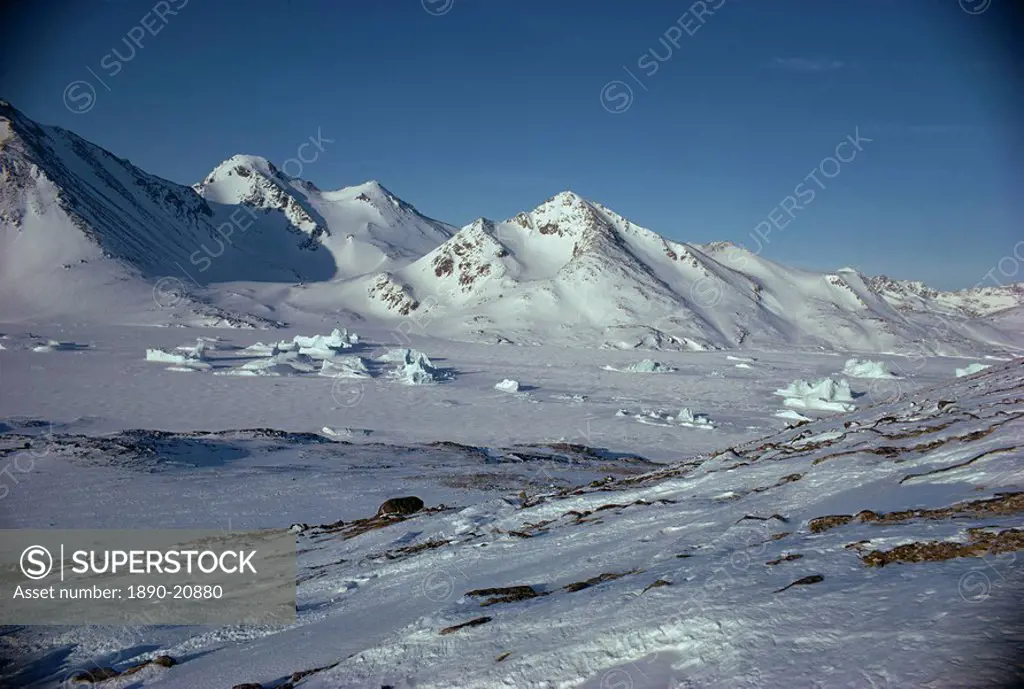 Rocky landscape and mountains covered in snow in Greenland, Polar Regions