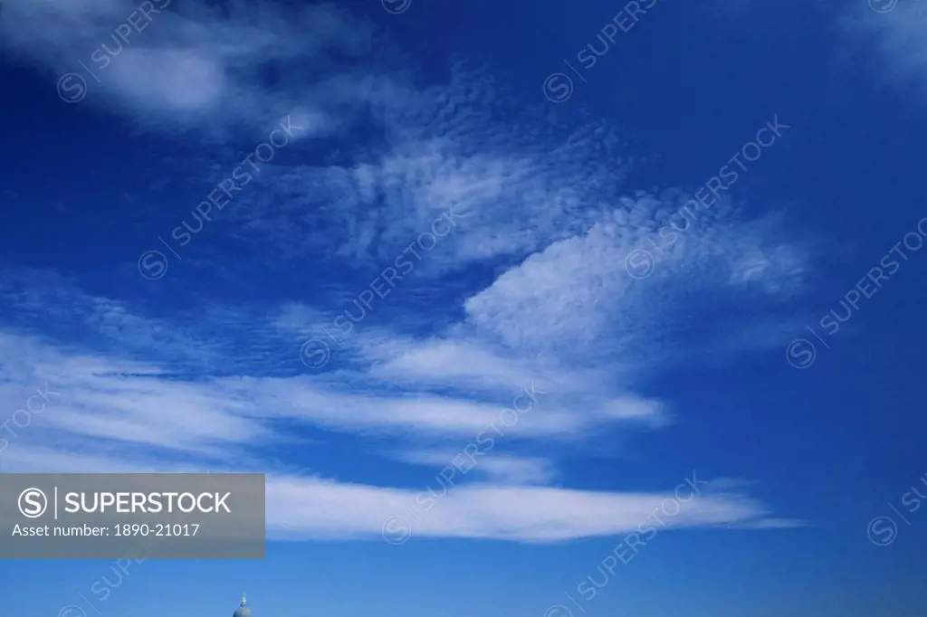 Streaks of white clouds in a blue sky