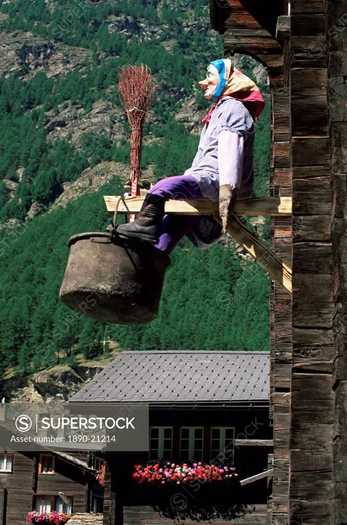 Witch hanging outside village house, Tasch, near Zermatt, Valais, Switzerland, Europe