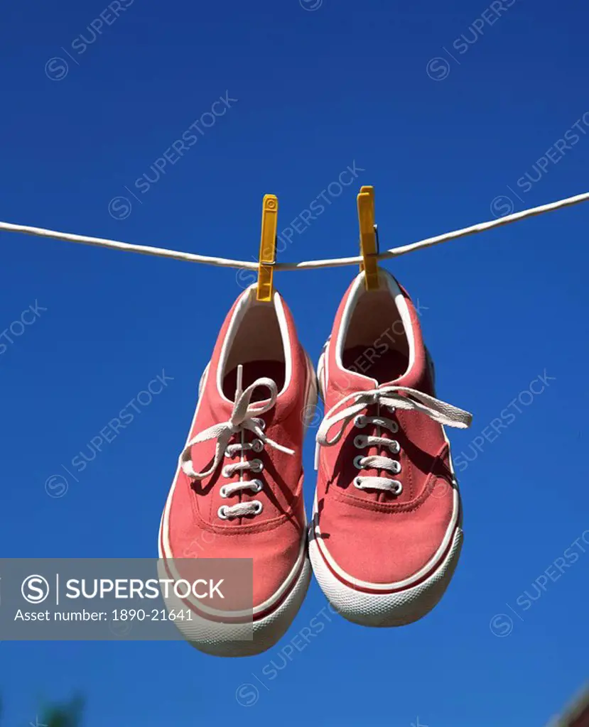 Pair of beach shoes on washing line