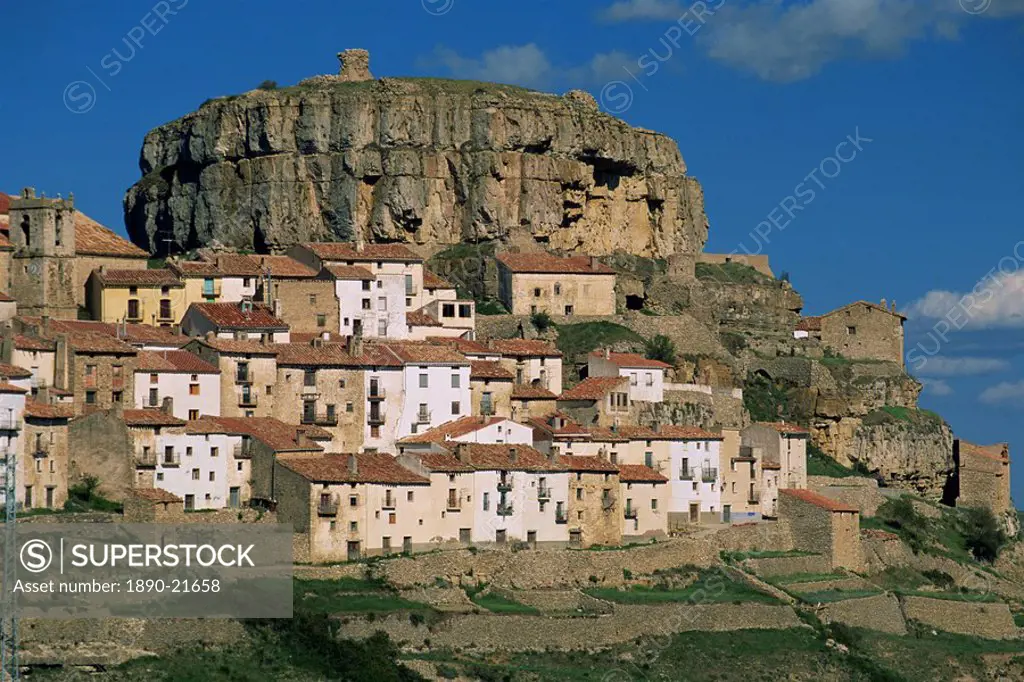 Houses overlook terraced fields, with rock cliff above the village of Ares del Maestre, Castellon, Valencia, Spain, Europe