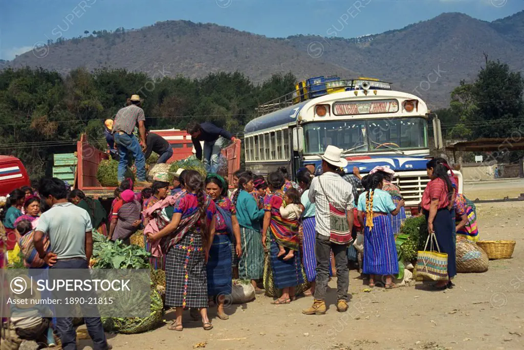 Men and women at the bus station during the Monday market at Antigua, Guatemala, Central America