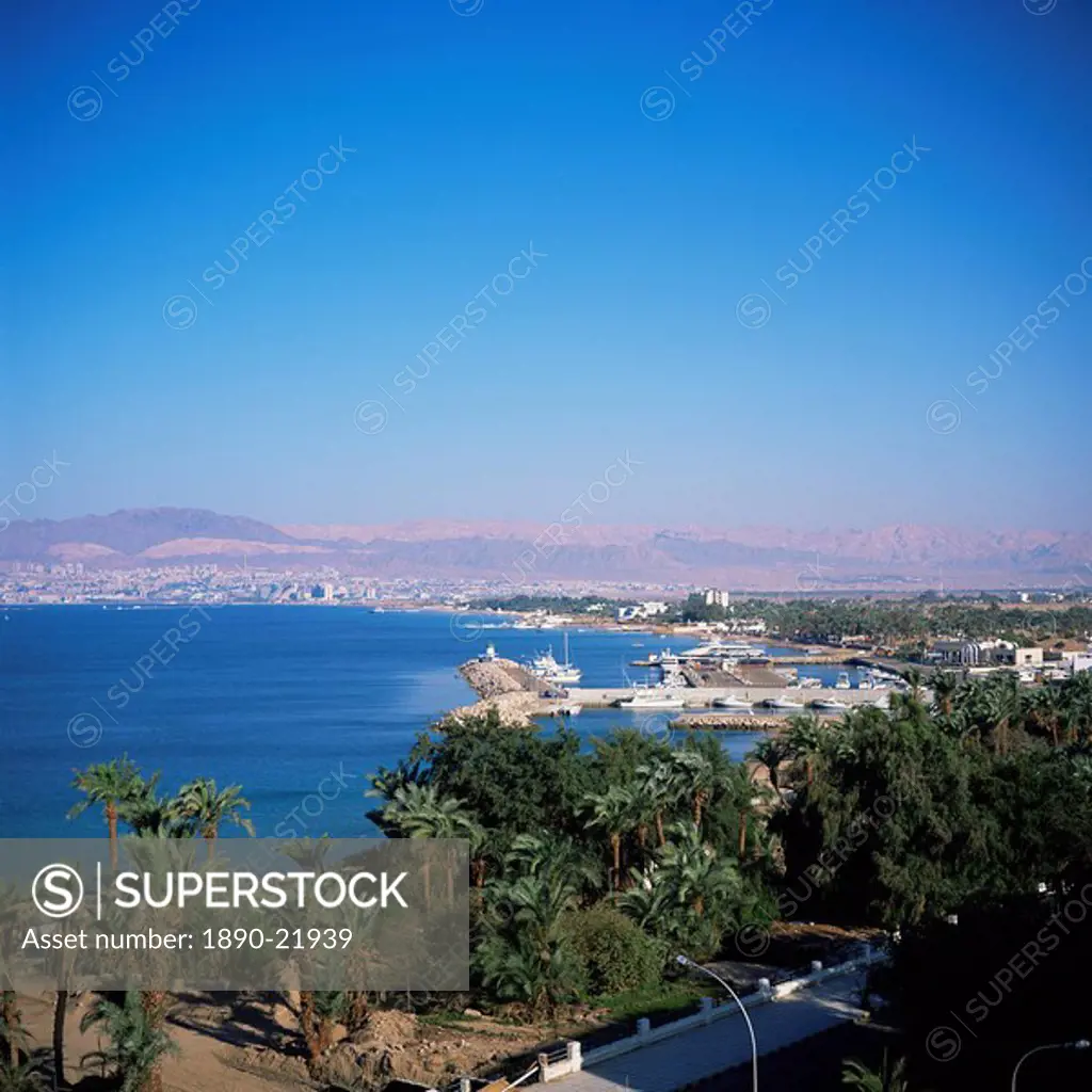 View over Red Sea resort marina and beach hotels towards Israeli town of Eilat, Aqaba, Jordan, Middle East