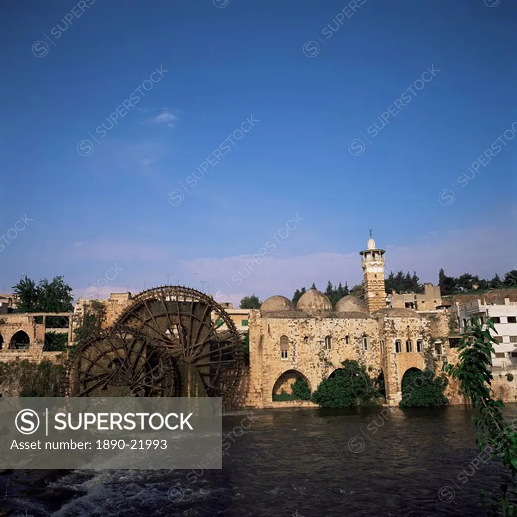 Waterwheels norias on the River Orontes, and Mosque al Nuri, dating from 1172, Hama, Syria, Middle East